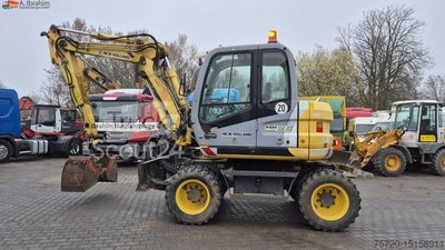 Mobile excavator New Holland MH 2.6 Condition good, German machine incl. Grippers and Dreservo used